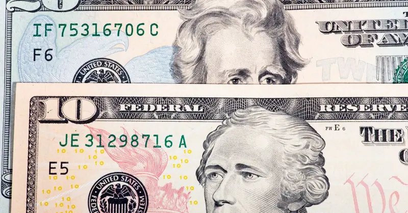 Detailed view of US ten and twenty dollar bills, highlighting design and texture.