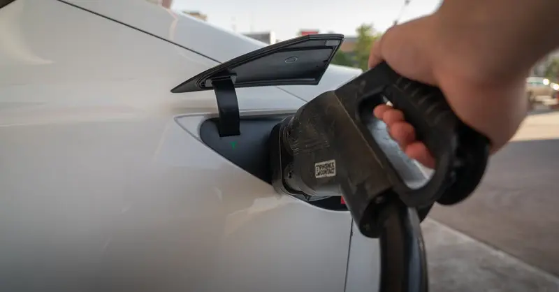 Close-up of electric car being charged, highlighting eco-friendly transportation.