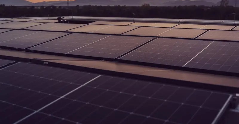 Solar panels in Styria, Austria under a serene sunset, showcasing renewable energy.