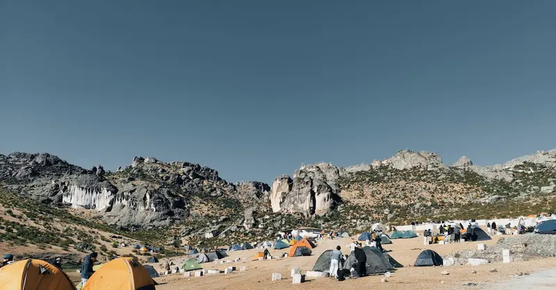 A scenic campsite in the Andes with colorful tents and rocky landscapes in San Pedro de Casta, Lima.