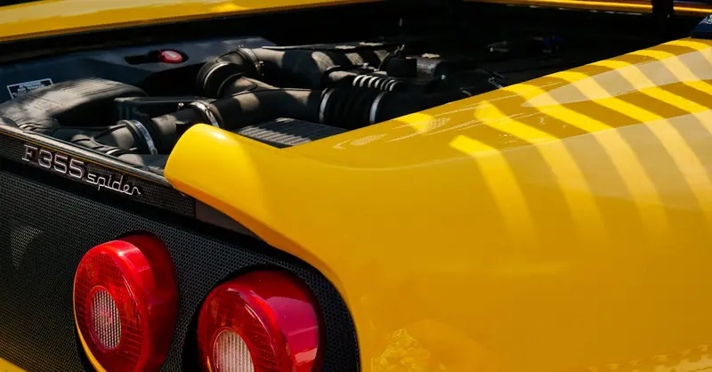 Detailed view of a yellow Ferrari F355 Spider at Noirmoutier-en-l'Île, ideal for automobile enthusiasts.