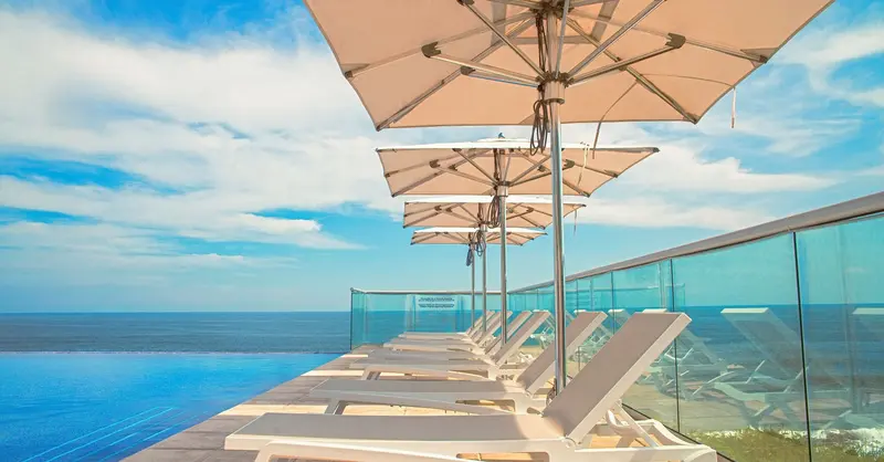 Relax by the infinity pool with ocean views at a luxurious El Salvador resort.