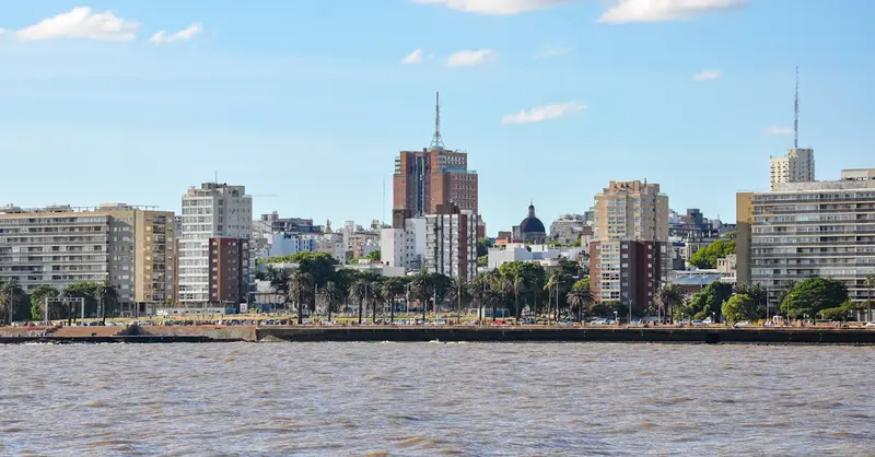 Skyline of Montevideo, Uruguay, overlooking the coastal waterfront under a bright blue sky.
