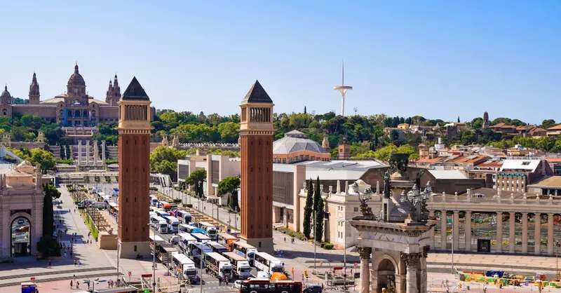 A vibrant aerial shot of Placa d'Espanya in Barcelona featuring iconic architecture and bustling city life.