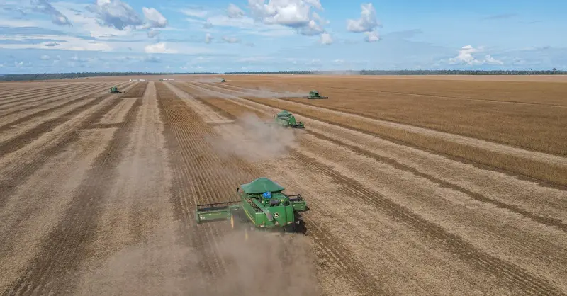 Soybean harvesters in action on a vast farm in Paragominas, Brazil, showcasing agricultural machinery.