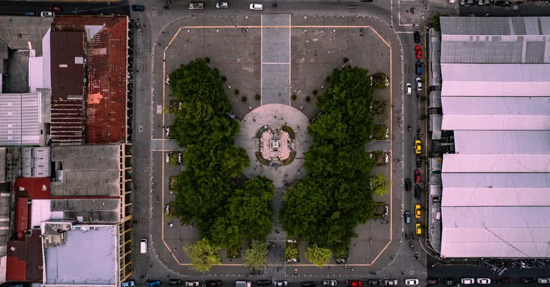Stunning aerial shot of a historic plaza amidst urban buildings in San Salvador, El Salvador.