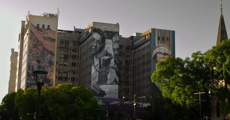 Hospital de Clínicas in Buenos Aires adorned with vivid murals, showcasing urban art.