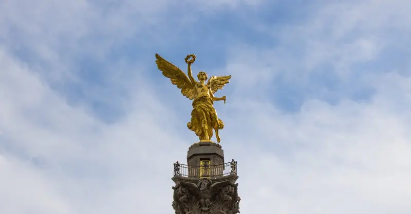 Stunning view of the Angel of Independence in Mexico City against a blue sky.