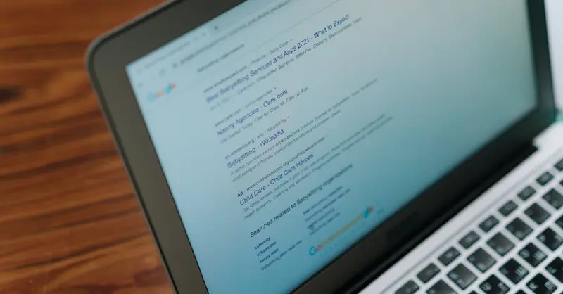 A close-up view of a laptop displaying a search engine page.