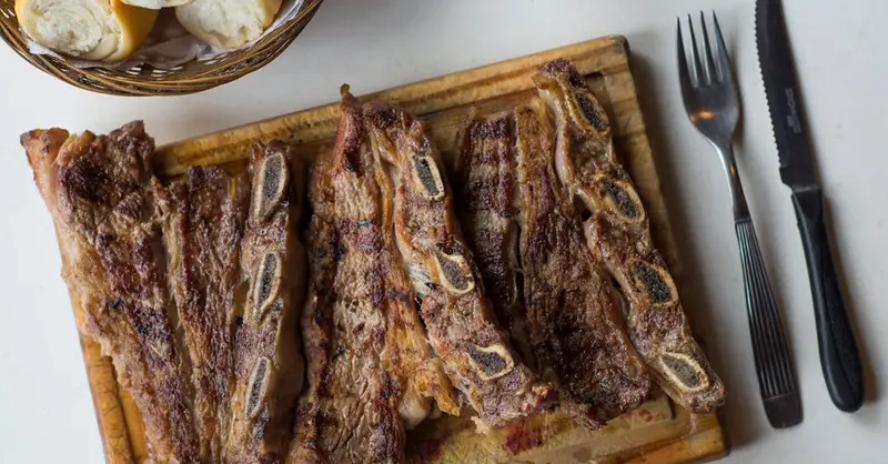 Delicious traditional Argentine asado, grilled steaks with bread, perfect for a classic meal.