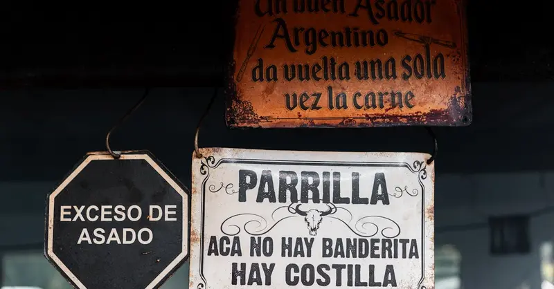 Vintage signs at an Argentinian grill highlighting asado culture in Uribelarrea.
