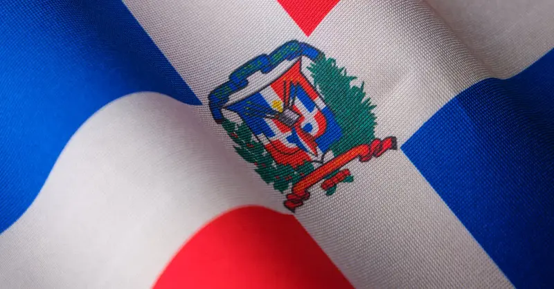 Close-up of the Dominican Republic flag featuring its emblem, symbolizing national pride.