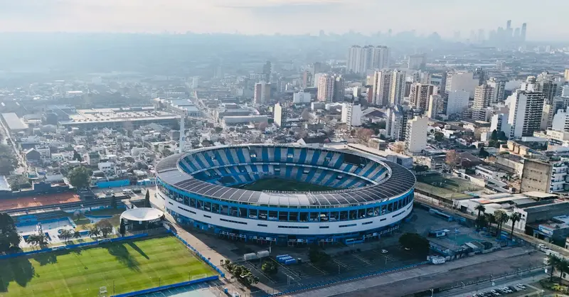 Aerial view of Avellaneda stadium in Buenos Aires with cityscape. Captures vibrant urban life.