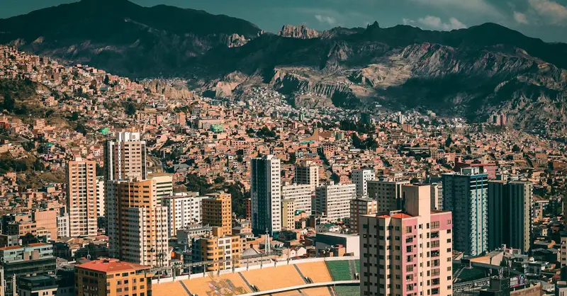 A stunning aerial view of La Paz, Bolivia with a backdrop of mountains and urban architecture.