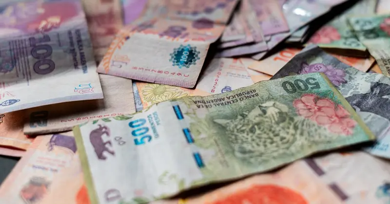 A detailed image showcasing various Argentine peso banknotes in vivid colors.