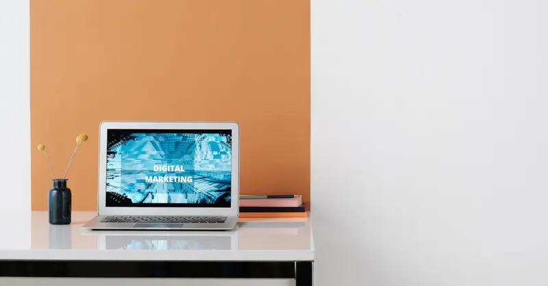 A clean, modern workspace featuring a laptop with digital marketing on screen, ideal for business use.