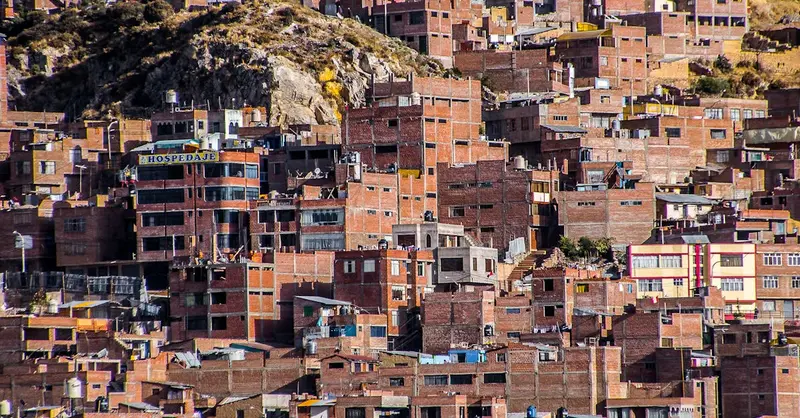 View of brick buildings densely packed on a hillside, showcasing urban architecture.
