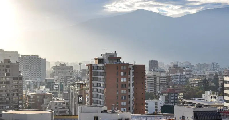 Beautiful morning view of Santiago, Chile, with the Andes mountains in the backdrop and urban architecture.