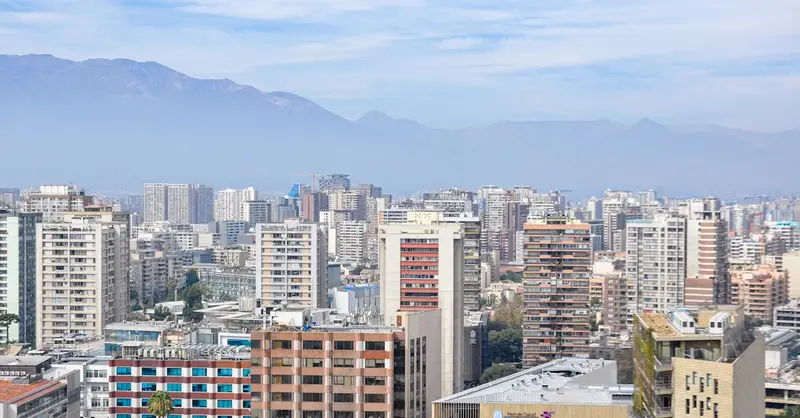 Stunning aerial view of Santiago, Chile, showcasing modern skyscrapers with mountain backdrop.