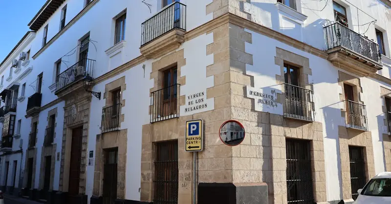 Elegant corner building in El Puerto de Santa María, highlighting classic Andalusian architecture.