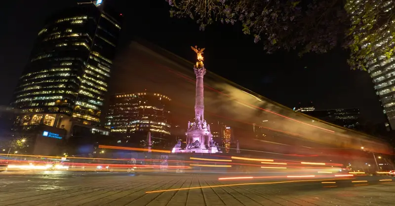 Dazzling night scene of Angel of Independence with light trails on Paseo de la Reforma, Mexico City.