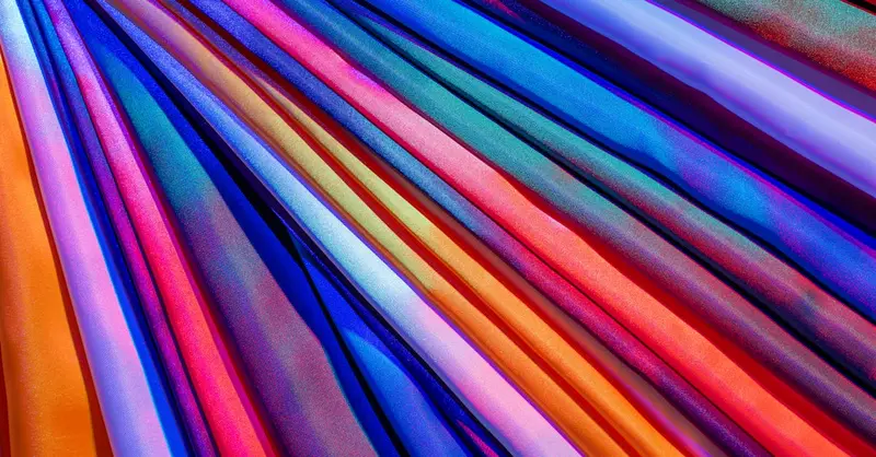 Bright and colorful satin fabric layered to create a vibrant and luxurious abstract background.