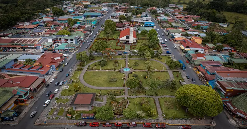 Bird's eye view of La Fortuna town in Costa Rica, capturing urban life and greenery.