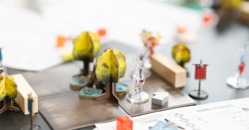 Detailed setup of a tabletop role-playing game with miniature figures and dice in San José, Costa Rica.