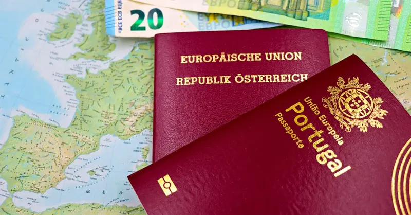 Austrian and Portuguese passports on a European map with euro banknotes.