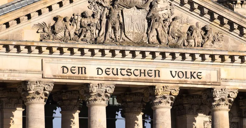 Close-up of the Reichstag facade in Berlin featuring ornate reliefs and columns.