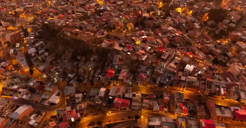 Mesmerizing aerial view of La Paz city at night, with bright city lights illuminating the bustling urban landscape.