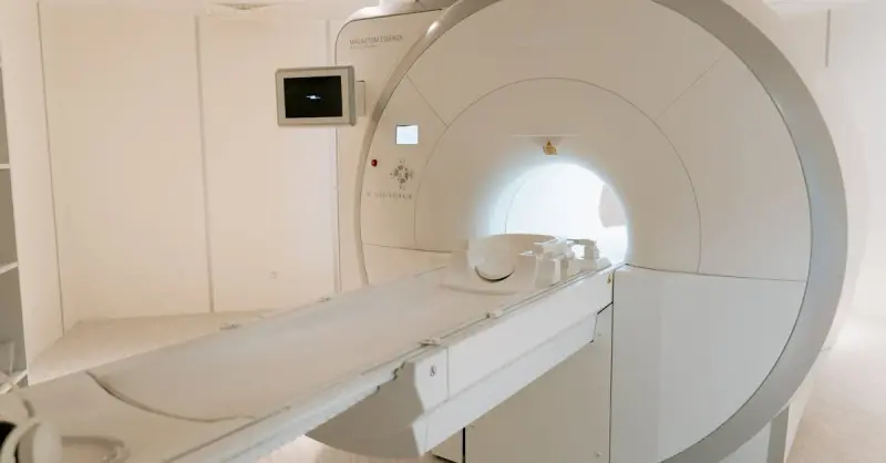 A state-of-the-art MRI scanner in a well-lit hospital room, ready for patient use.