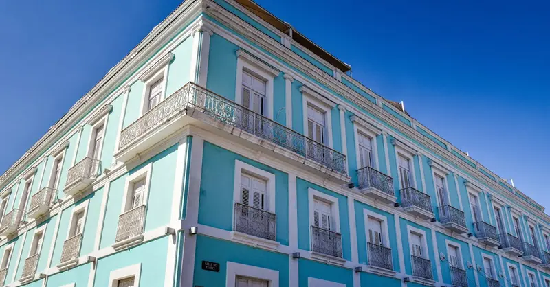 Beautiful colonial-style hotel facade under clear blue skies in Cienfuegos, Cuba.