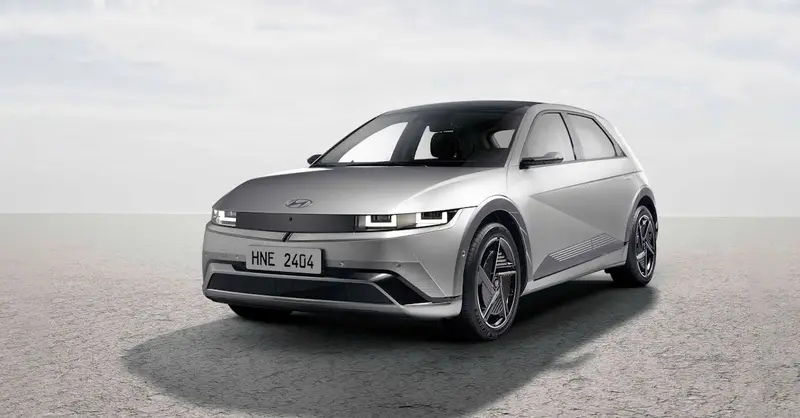 A modern Hyundai Ioniq 5 electric car parked outdoors on a cloudy day.