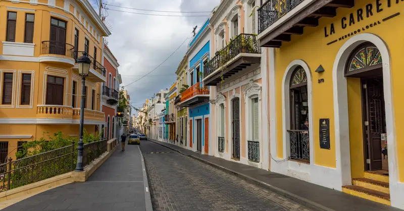 Vibrant historic street view with colorful colonial buildings in Old San Juan, Puerto Rico.