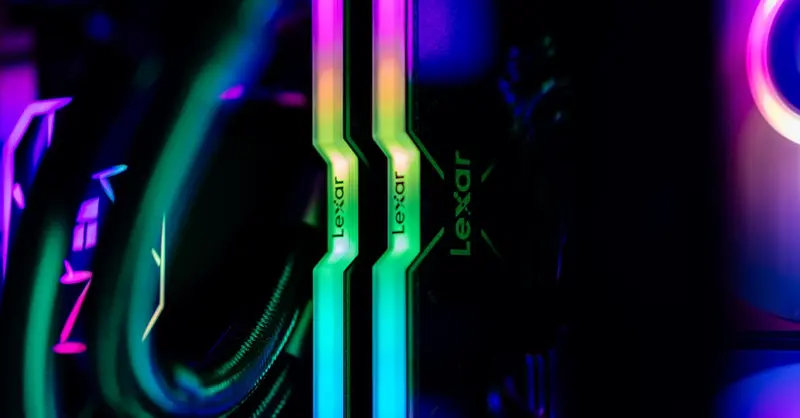 Close-up of RGB lighting on Lexar memory sticks inside a custom gaming PC case, showcasing modern technology.