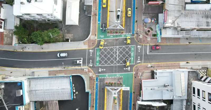 Drone capture of busy intersection in Santo Domingo, Ecuador, showcasing urban traffic flow and city infrastructure.