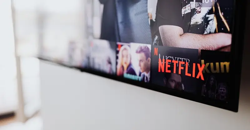 Selective focus of a Netflix screen on a smart TV in an indoor setting.