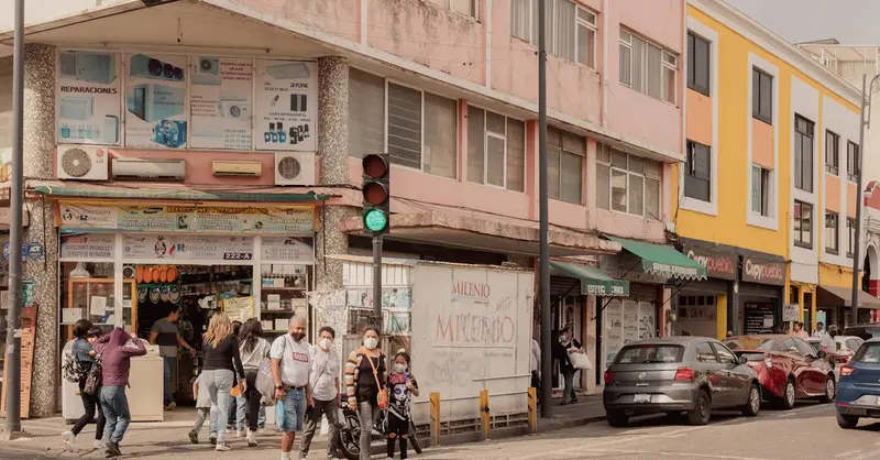 Vibrant street view in Puebla, Mexico with colorful buildings and pedestrians.