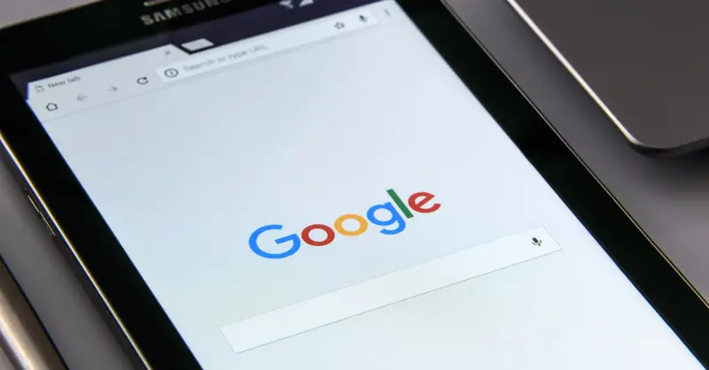 Close-up of a tablet displaying Google's search screen, emphasizing technology and internet browsing.