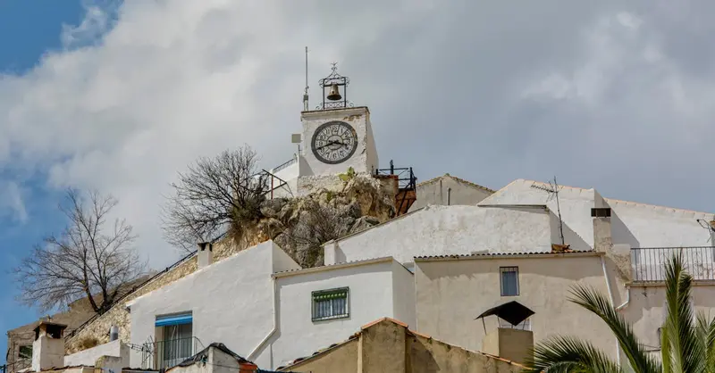 Scenic view of the historic clock tower in Torres, Spain against a cloudy sky.