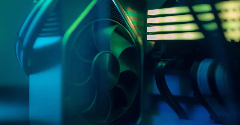 Detailed close-up of a computer cooling fan inside a custom PC with LED lighting, emphasizing technology and design.