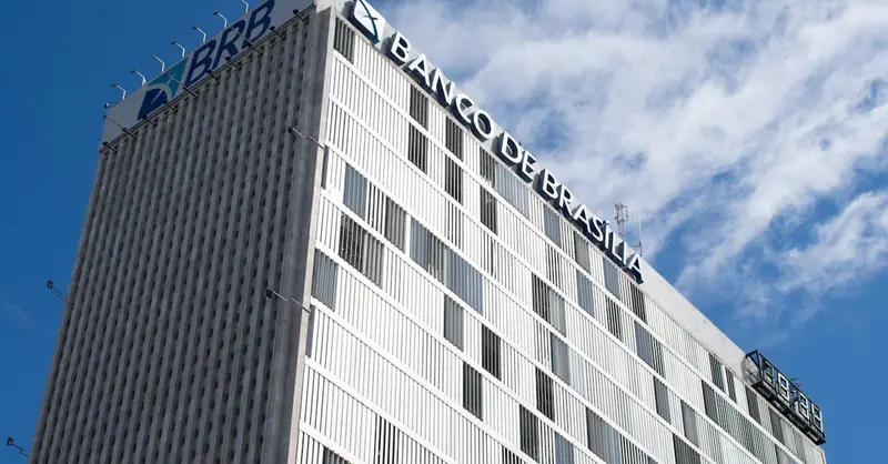 High-rise view of Banco de Brasília against a bright blue sky in Distrito Federal, Brazil.