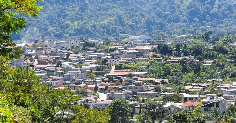 Captivating aerial view of a town surrounded by lush greenery in Ciudad de Guatemala, capturing the essence of local architecture.