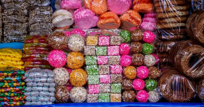 Vibrant display of traditional Guatemalan sweets at a market stall. Perfect for celebrating local culture.