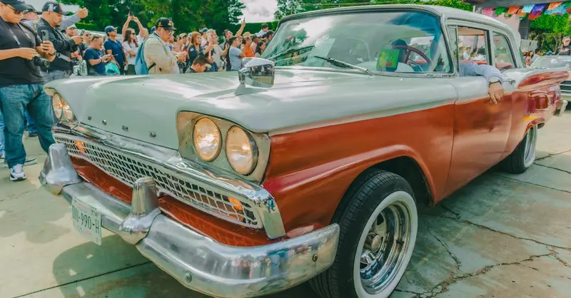 Vintage car showcased at a lively event in Comitán de Domínguez, Chiapas, Mexico.
