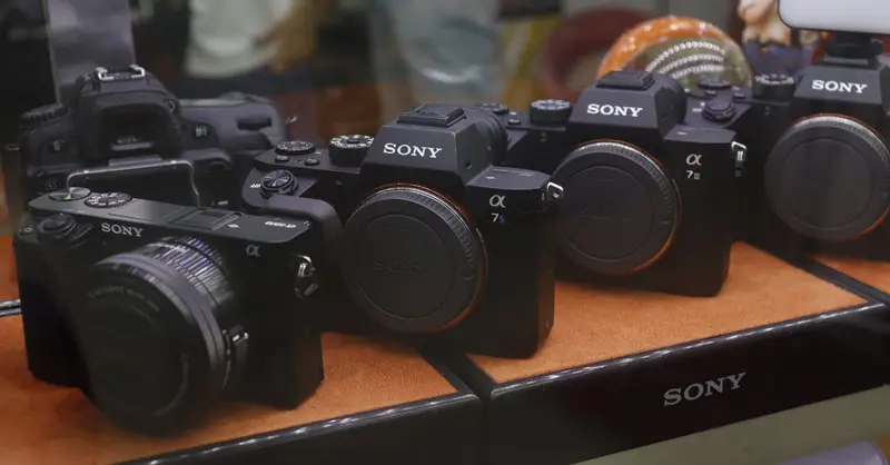 A collection of Sony digital cameras showcased in a store display case.