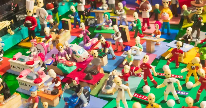 Vibrant miniature scene capturing Day of the Dead activity with skeleton figures in Toluca.