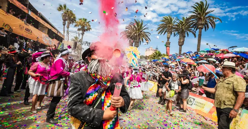Colorful carnival in Arica, Chile with festive dancers, music, and cheerful crowds