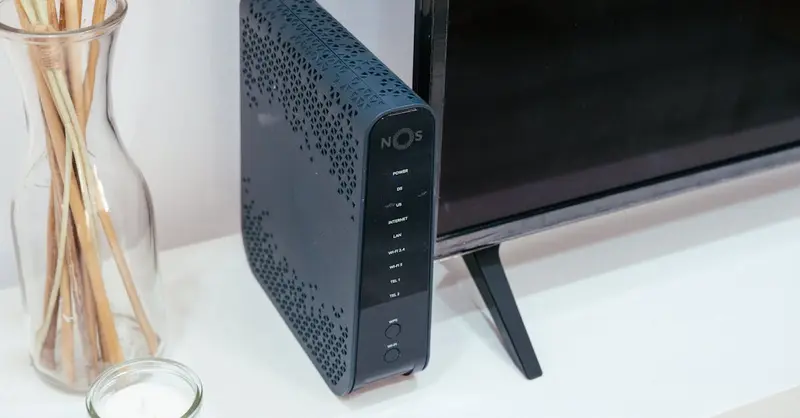 A sleek home technology setup featuring a router, glass decoration, and television.